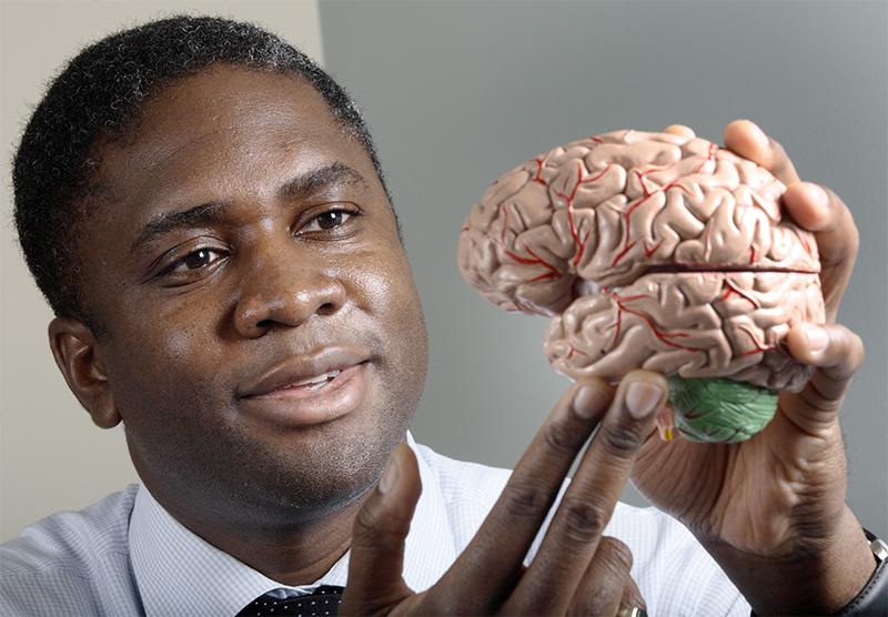 Dr Chiadi Onyike with brain model